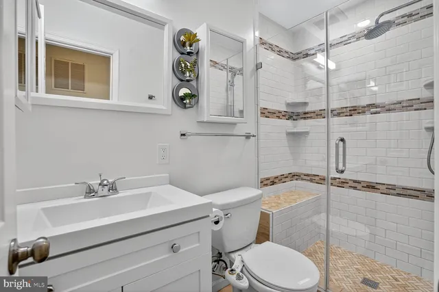 a bathroom with a sink toilet and shower