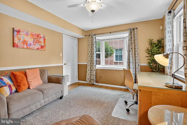 a bedroom with a bed couch and a flat screen tv
