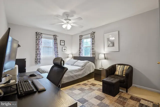 a bedroom with a bed and a desk