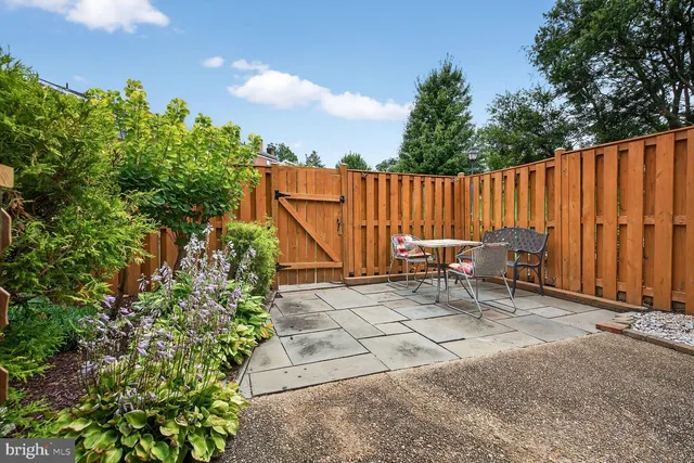 a view of backyard with a table and chairs
