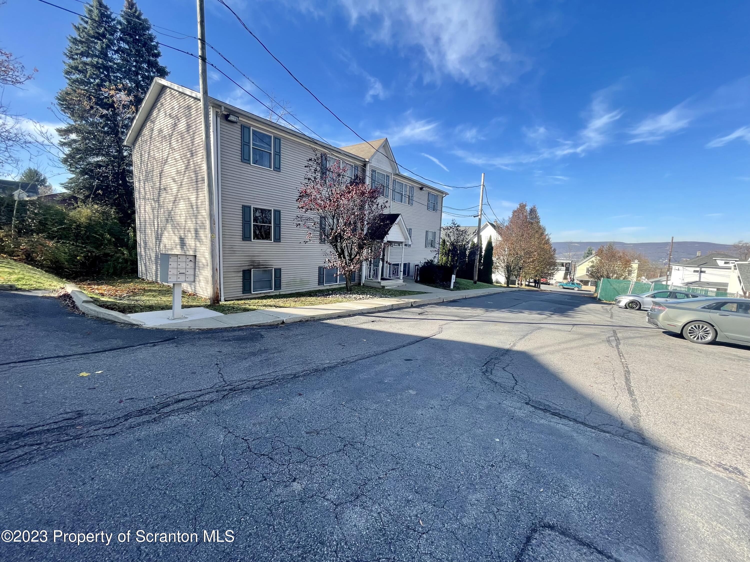 131 Smith Street, Unit A4 Dunmore, PA 18512 - Photo 2 of 12 a view of the house with a swimming pool