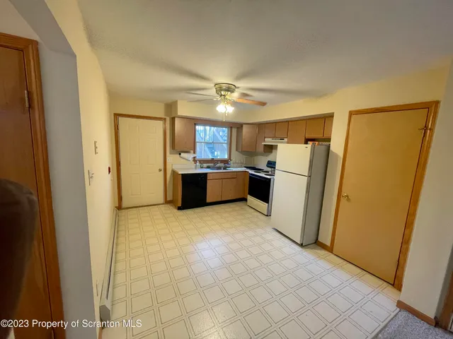 a kitchen with refrigerator a stove top oven and a refrigerator