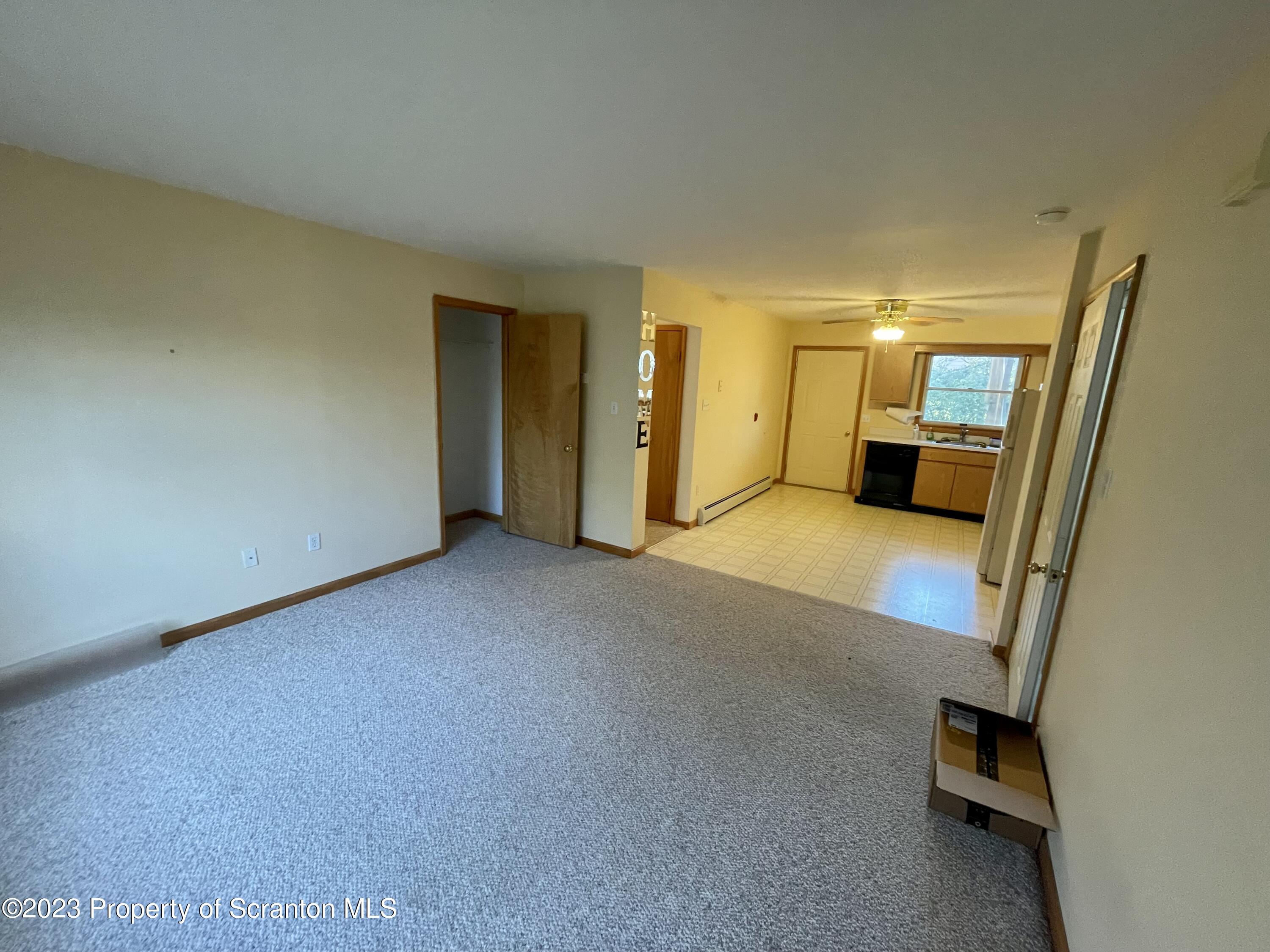 131 Smith Street, Unit A4 Dunmore, PA 18512 - Photo 6 of 12 an empty room with a mirror