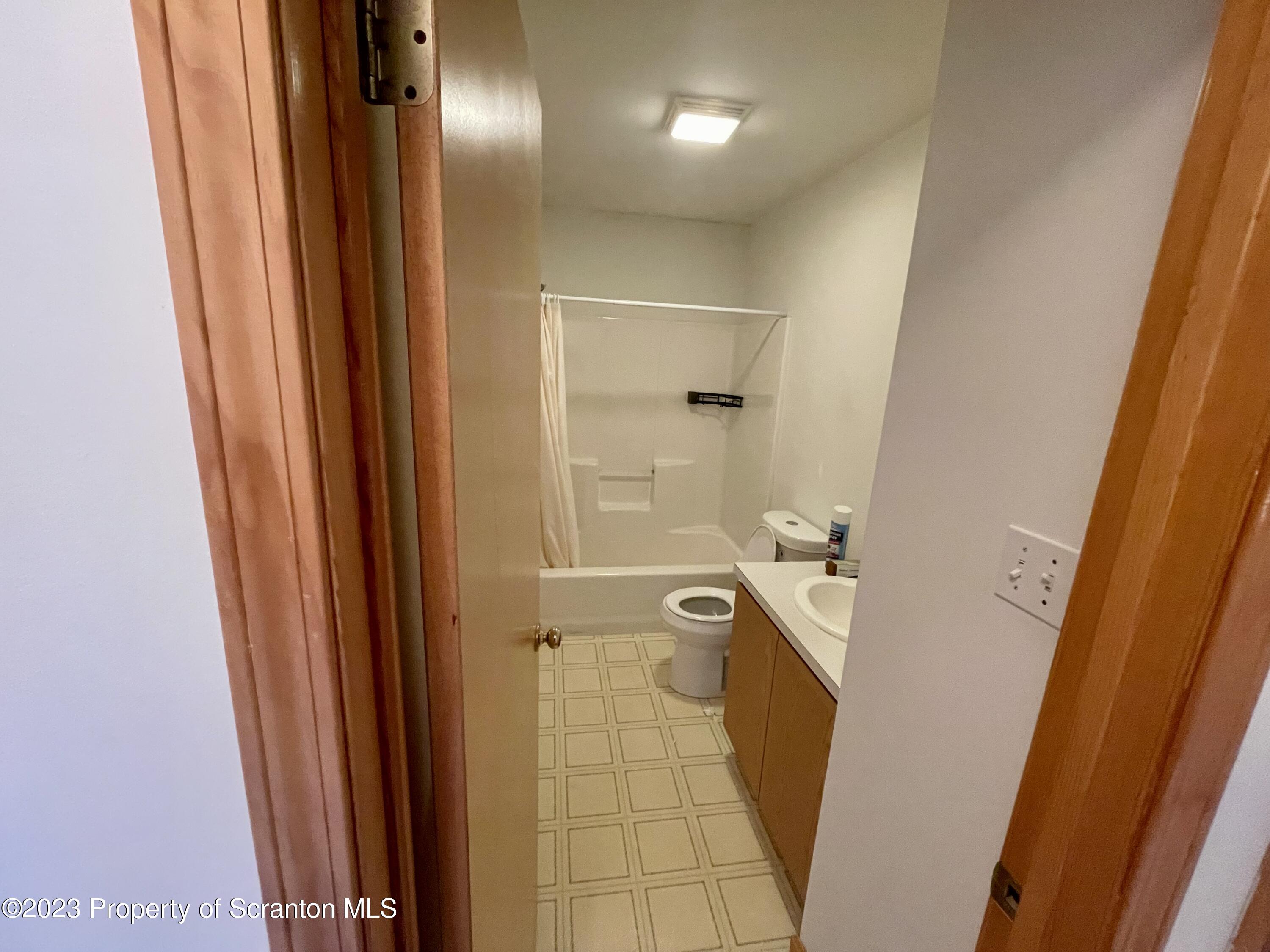 131 Smith Street, Unit A4 Dunmore, PA 18512 - Photo 8 of 12 a bathroom with a sink a toilet and shower