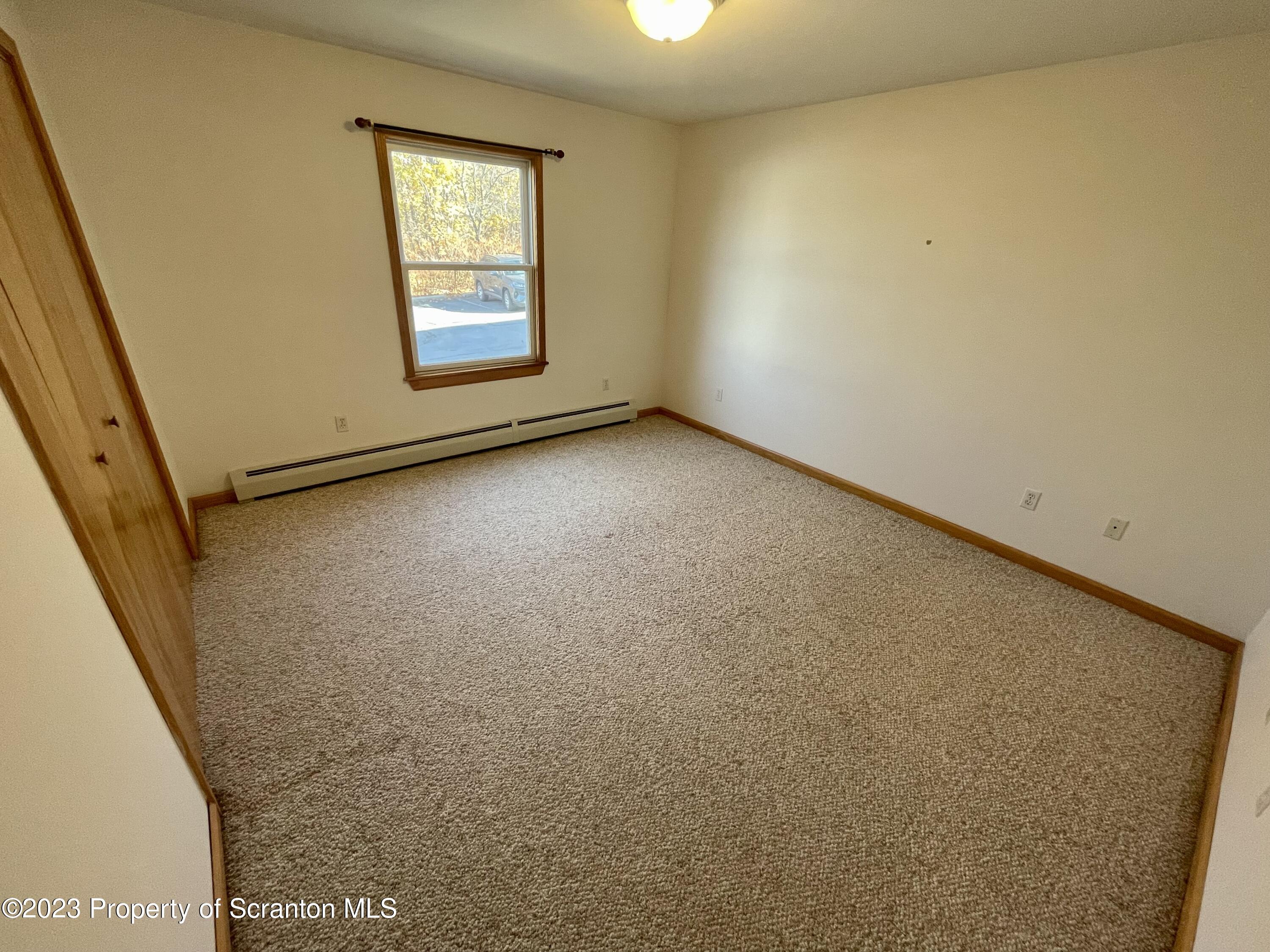 131 Smith Street, Unit A4 Dunmore, PA 18512 - Photo 9 of 12 an empty room with windows