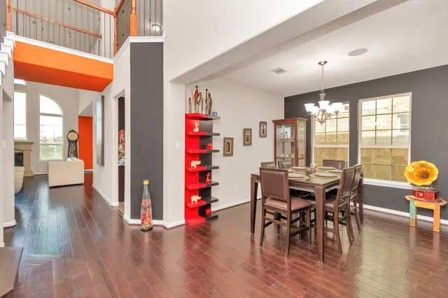 a view of a dining room with furniture and wooden floor