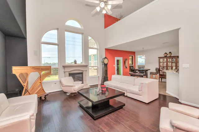 a living room with furniture fireplace and a large window