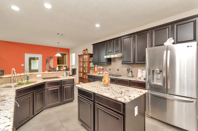a kitchen with a sink stove and refrigerator