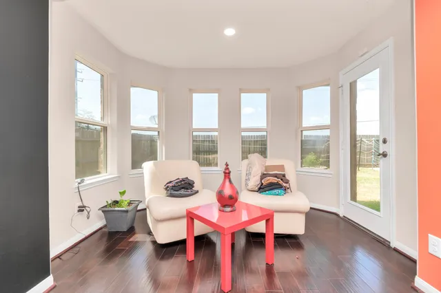 a living room with furniture and wooden floor