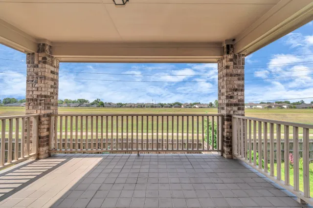 a view of a balcony with wooden floor