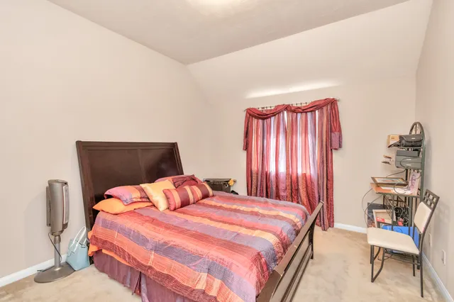 a bedroom with a bed and a chair