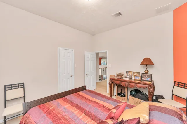 a bedroom with a bed and a table in it