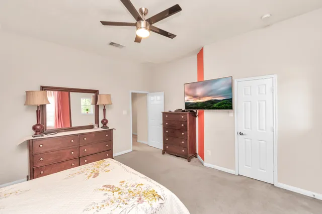 a bedroom with a bed and a dresser