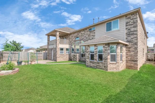 a view of a house with a yard and sitting area