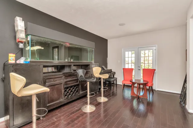 a living room with furniture a dining table and wooden floor