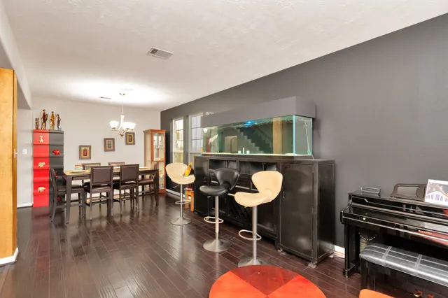 a living room with furniture a rug and a piano