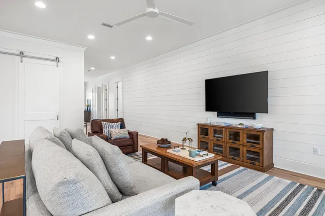 a living room with furniture and kitchen view