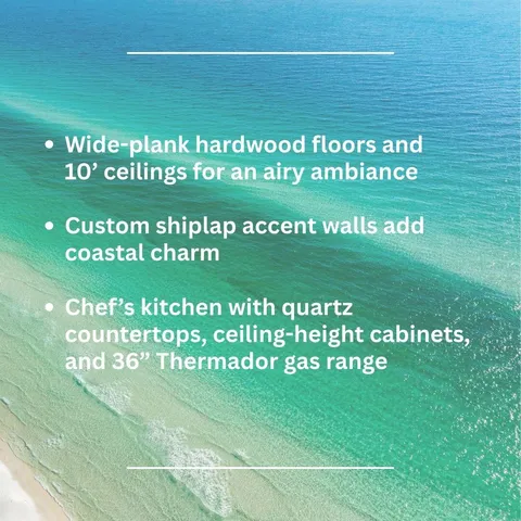 a view of a hallway with wooden floor and furniture