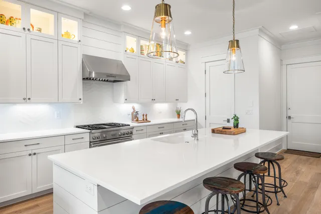 a kitchen with stainless steel appliances a sink a stove and cabinets