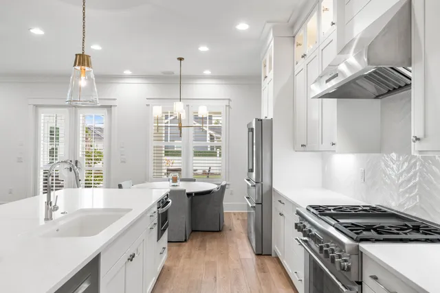 a bedroom with a bed a window and a chandelier
