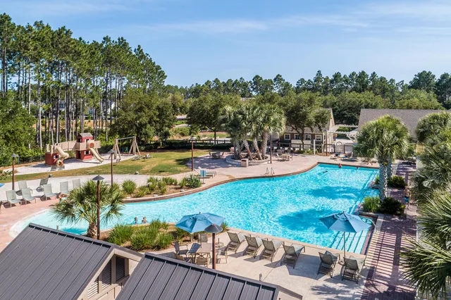 an aerial view of a house with a yard and lake view