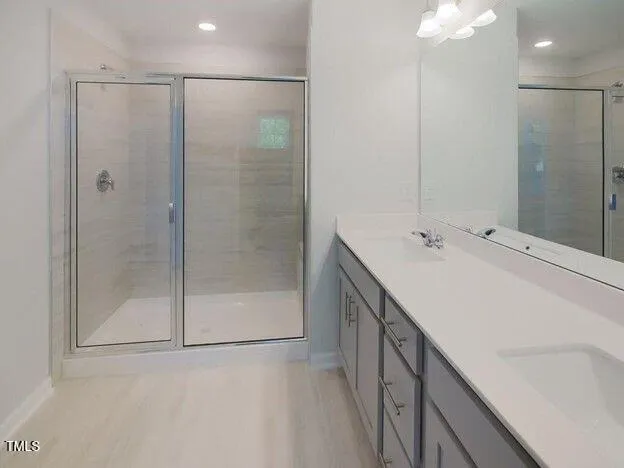 a bathroom with a double vanity sink a mirror and a shower