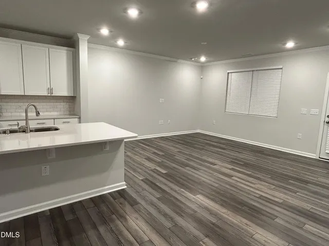 a view of kitchen with wooden floor and electronic appliances