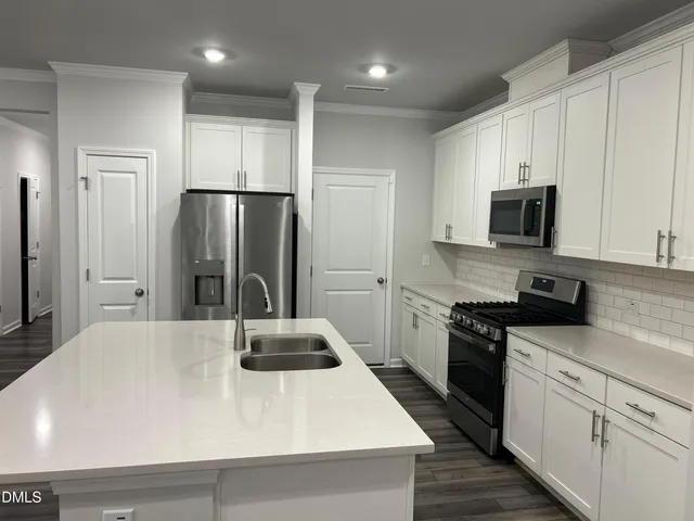 a kitchen with a refrigerator and a sink