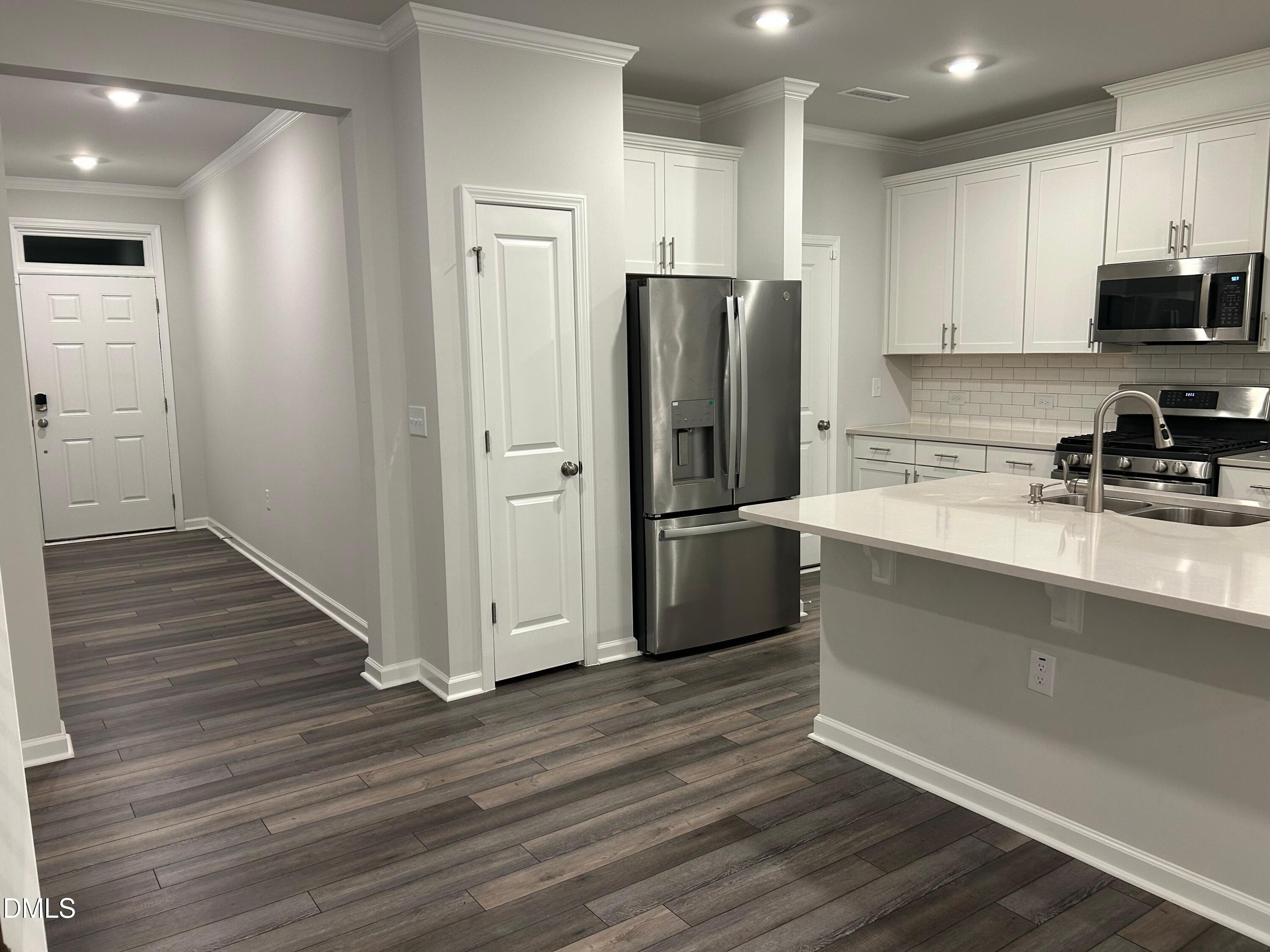 113 Vanilla Orchid Lane Garner, NC 27529 - Photo 20 of 32 a kitchen with a refrigerator and a sink