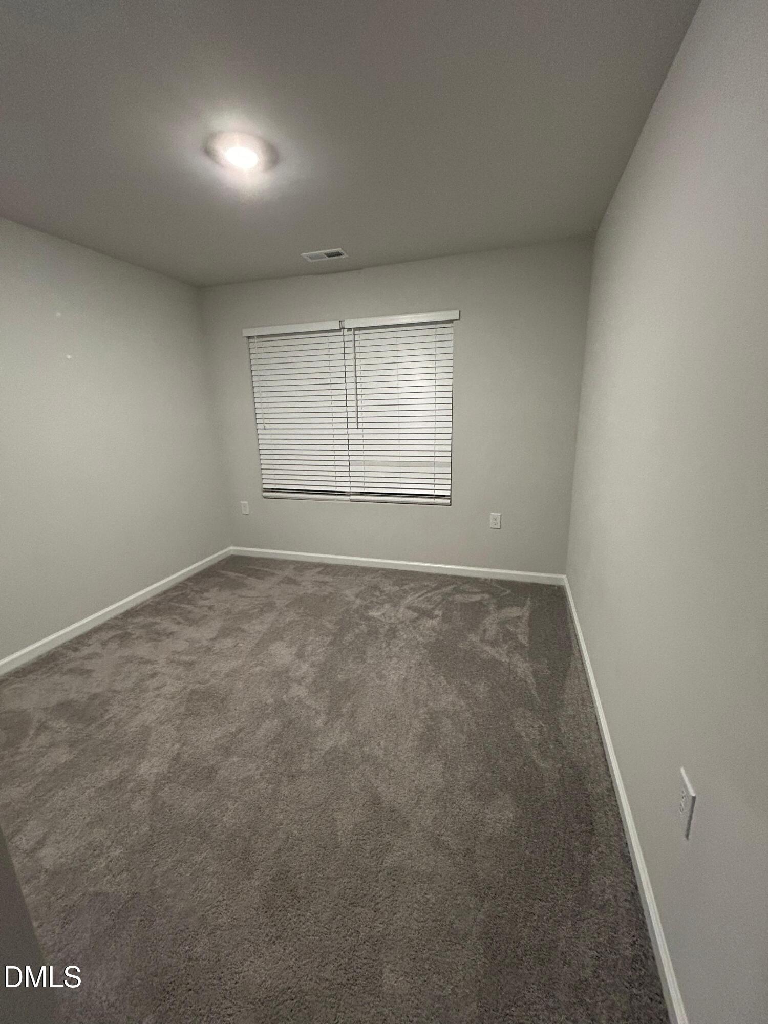 113 Vanilla Orchid Lane Garner, NC 27529 - Photo 25 of 32 an empty room with a empty space and windows