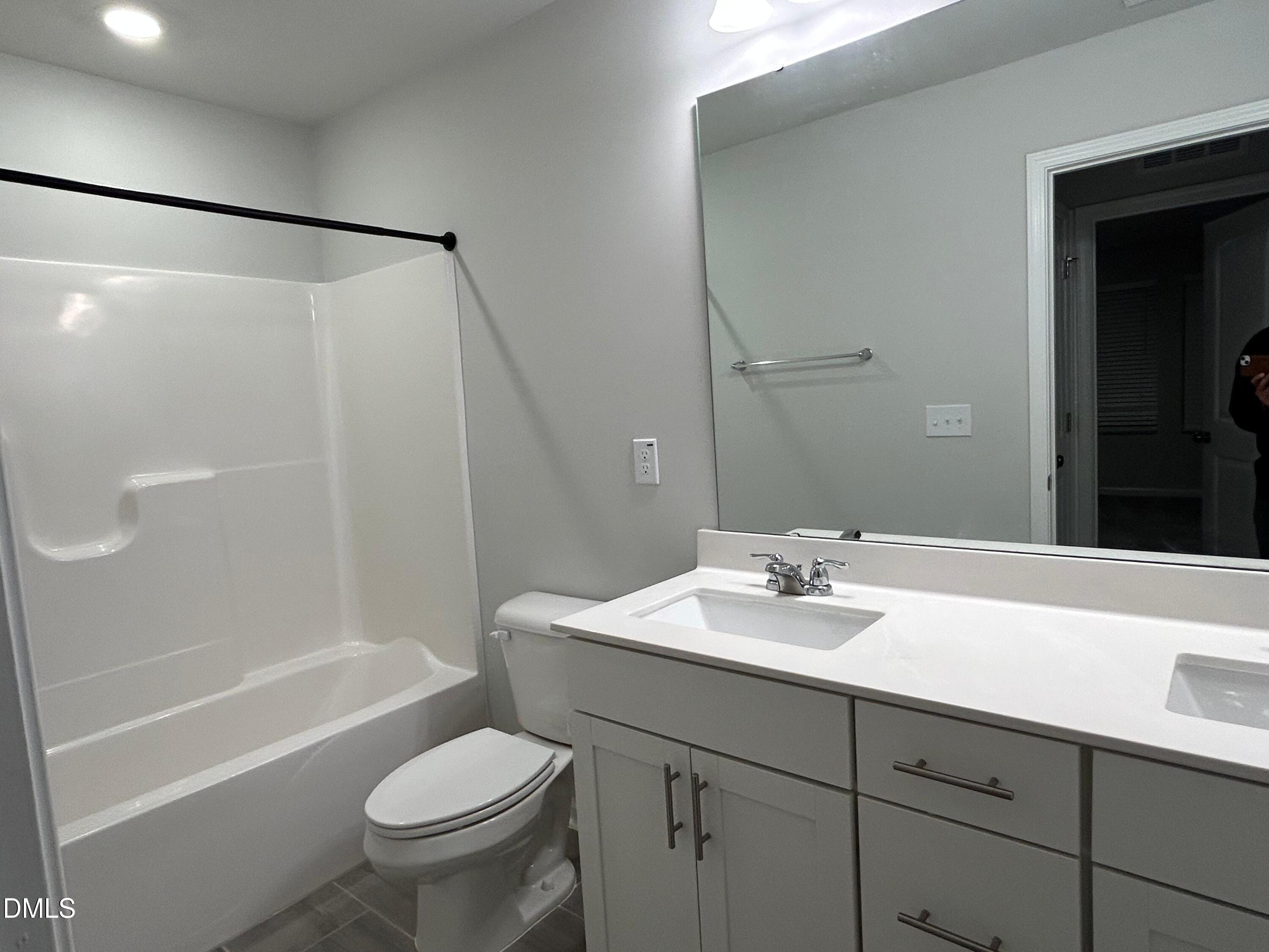 113 Vanilla Orchid Lane Garner, NC 27529 - Photo 27 of 32 a bathroom with a sink toilet and shower