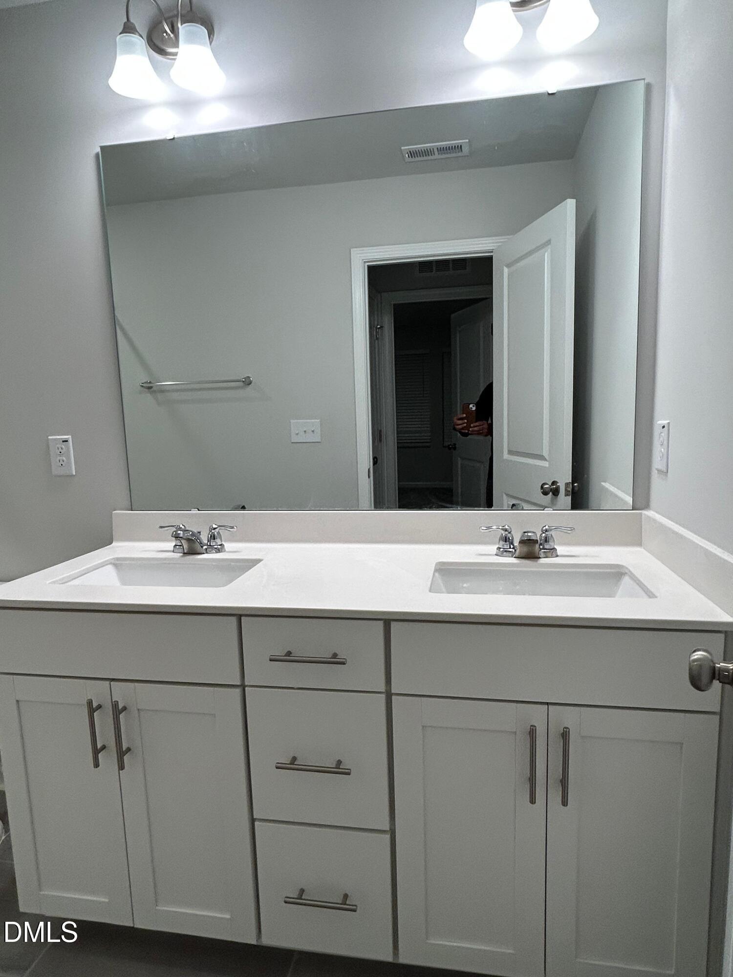 113 Vanilla Orchid Lane Garner, NC 27529 - Photo 28 of 32 a bathroom with a sink and a mirror