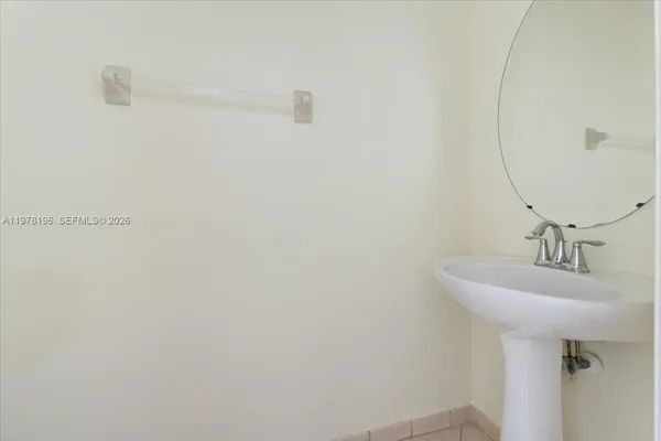 a bathroom with a sink and mirror