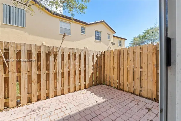 a view of a house with wooden fence