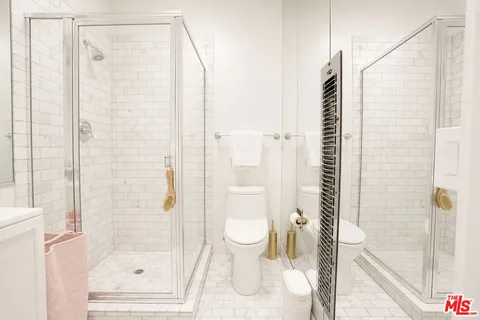 a bathroom with a shower and a toilet