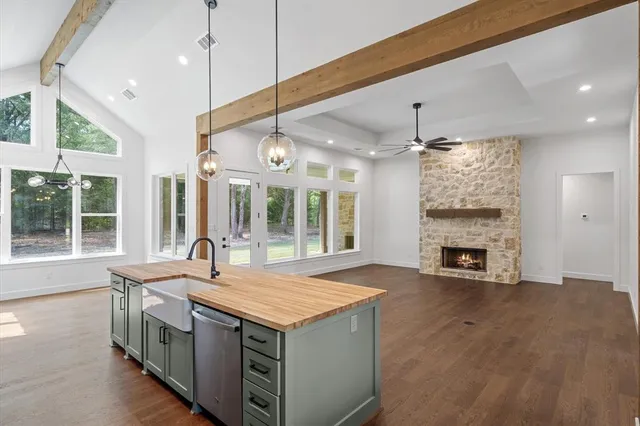 a open kitchen with a sink and a fireplace