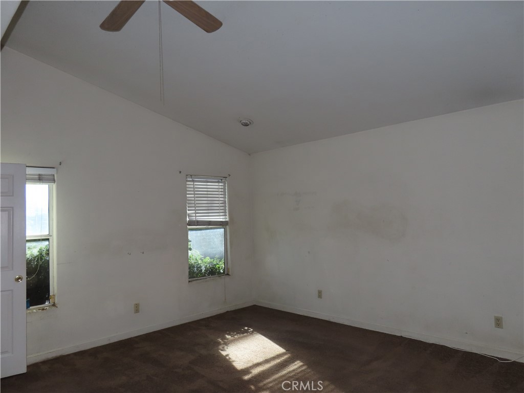 418 West Randall Avenue Rialto, CA 92376 - Photo 13 of 17 an empty room with windows and ceiling fan