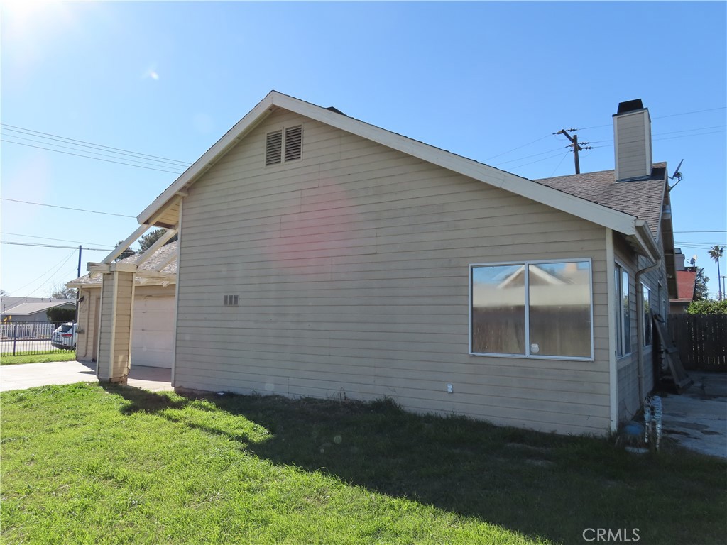 418 West Randall Avenue Rialto, CA 92376 - Photo 16 of 17 a front view of a house with garden