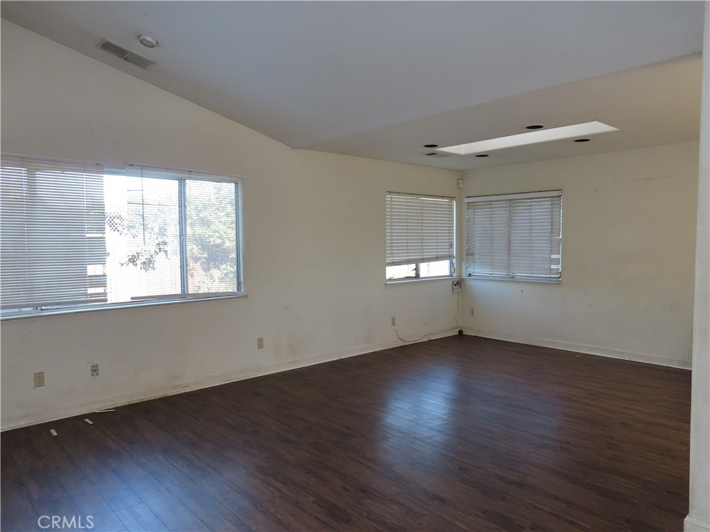 418 West Randall Avenue Rialto, CA 92376 - Photo 5 of 17 a view of an empty room with wooden floor and a window