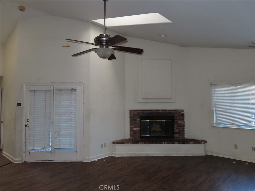418 West Randall Avenue Rialto, CA 92376 - Photo 6 of 17 a living room with a fireplace and a ceiling fan
