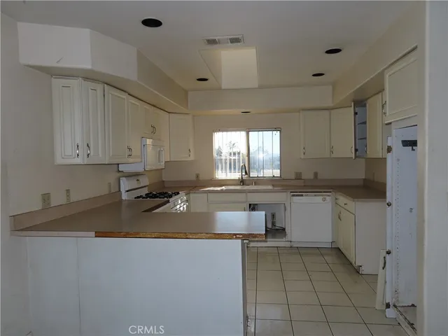 a kitchen with a sink a stove and cabinets