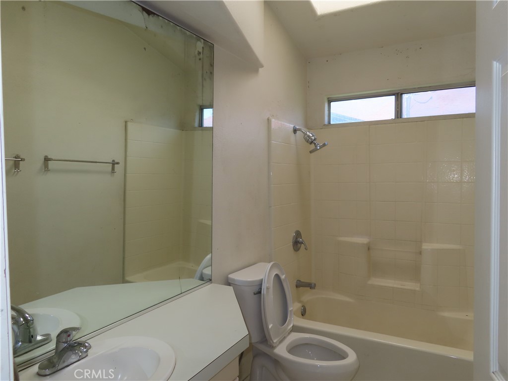 418 West Randall Avenue Rialto, CA 92376 - Photo 10 of 17 a bathroom with a sink a toilet and shower