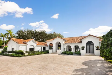 a view of white house with a yard