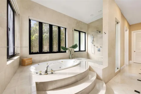 a bath tub sitting in a bathroom next to a window