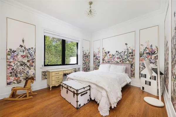 a living room with a bed furniture and a window