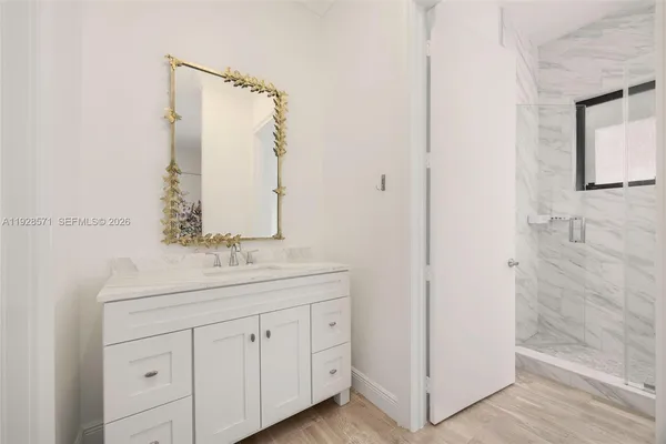 a bathroom with a double vanity sink and mirror
