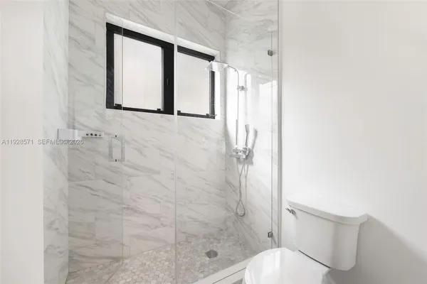 a bathroom with a toilet and a shower