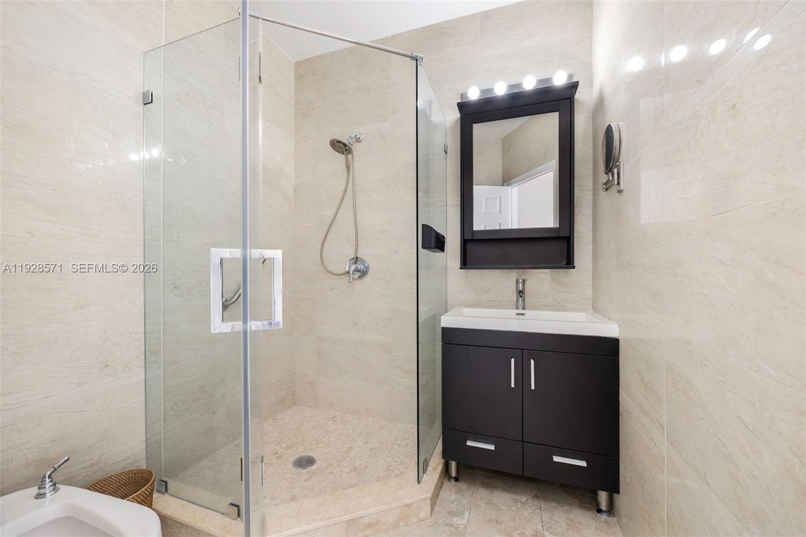 7430 Southwest 66th Street Miami, FL 33143 - Photo 25 of 43 a bathroom with a sink a toilet and shower