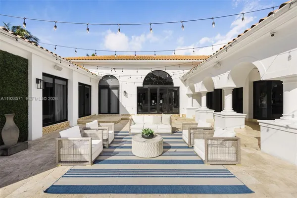 a front view of house with yard entertaining space and outdoor seating