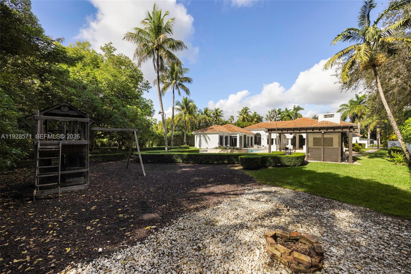 7430 Southwest 66th Street Miami, FL 33143 - Photo 36 of 43 a front view of a house with a garden